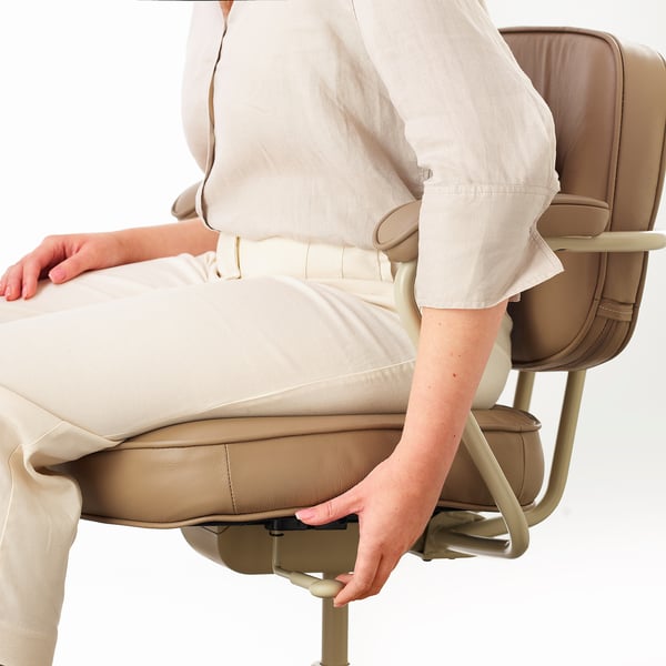 Person adjusting office chairs armrest.