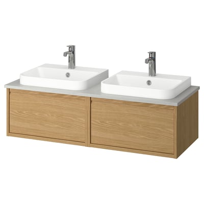 Double oak vanity with two white basins, chrome faucets, minimalist handles, clean lines.