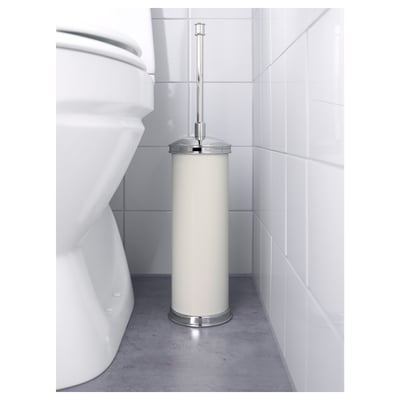 Cylindrical white brush holder with chrome handle beside white toilet, part of the BALUNGEN series, designed for replaceable brush head.