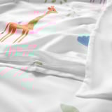 Duvet cover with vibrant giraffe print, fine cotton material, visible zipper detail, soft and breathable.