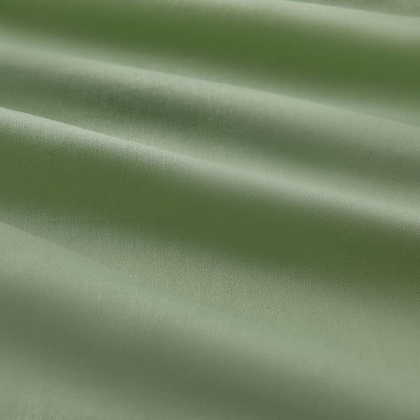 Close-up of lush green fabric, soft with subtle sheen, smooth texture, showcasing fine weave quality.