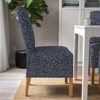 BERGMUND chair with floral navy blue cover, wooden legs, high back, and comfortable seat.