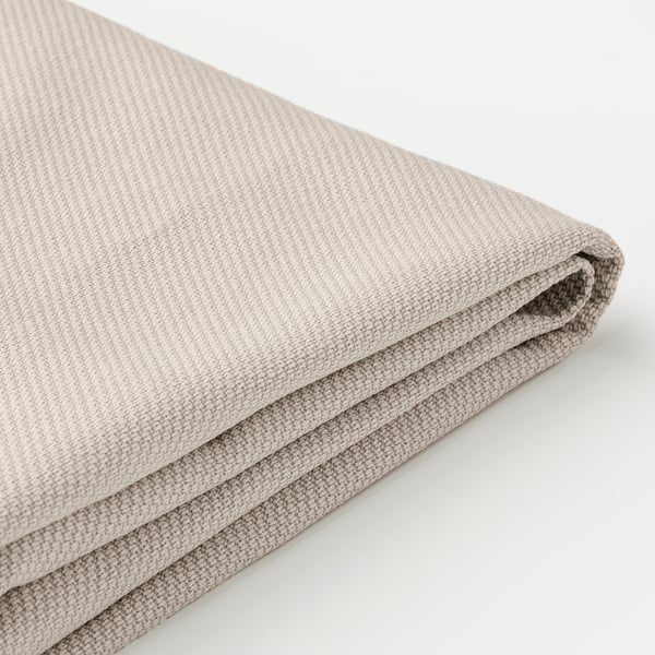 Folded fabric stool cushion, soft textured, beige colored.