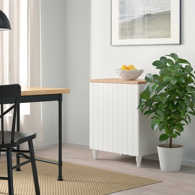 Modern interior with BESTÅ storage unit, dining table, and decor.