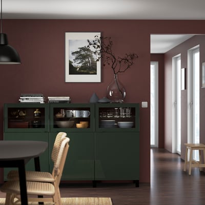 BESTÅ sideboard with crockery, art, vase & branches. Near dining table, hallway & doors.