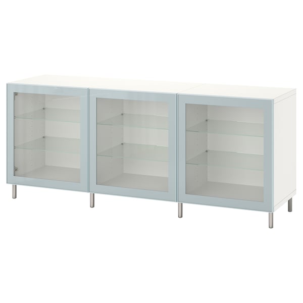 This image shows a white BESTÅ sideboard with three glass doors and metal legs. It adjustable shelves for versatile storage.