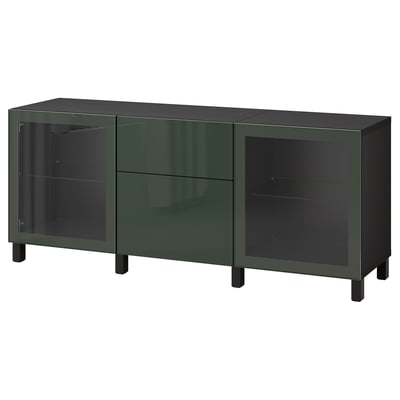 A green BESTÅ sideboard with glass doors and a glossy finish. Its rectangular with black legs.