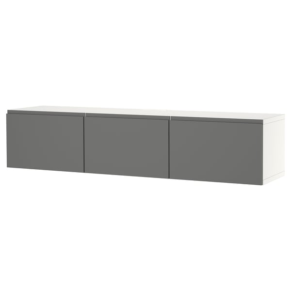 A modern, wall-mounted tv bench named BESTÅ with three gray doors, offering ample storage and cable management solutions.