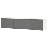 A modern, wall-mounted tv bench named BESTÅ with three gray doors, offering ample storage and cable management solutions.