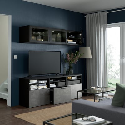 Modern black and gray tv stand with glass-door cabinets and adjustable shelves for storage.