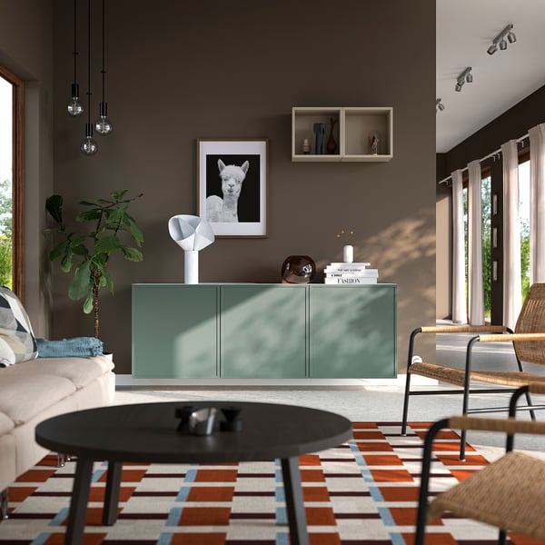 Modern living room: teal sideboard, rug, alpaca art, large windows.