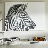 Black-and-white zebra canvas art above dining table with chairs and plates.