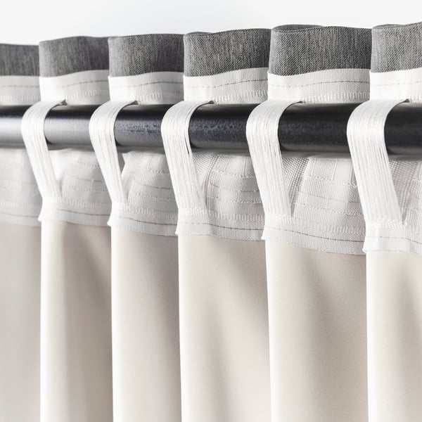 Curtain rod with hanging hooks. The hooks attach curtains to block light and ensure privacy.