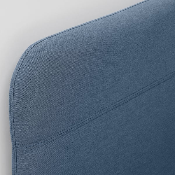 Blue upholstered bed frame corner, showcasing quality fabric and stitching.