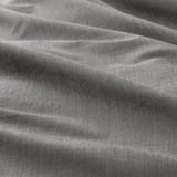 Close-up of soft, crisp fabric with subtle patterned stripes; high-quality cotton weave.