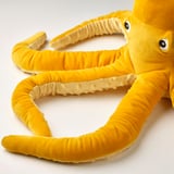 Plush toy octopus with woven body, textured sucker arms, embroidered eyes, showcasing detailed craftsmanship.