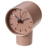 Rose-pink BONDTOLVAN alarm clock; circular face, cylindrical base, sleek design.