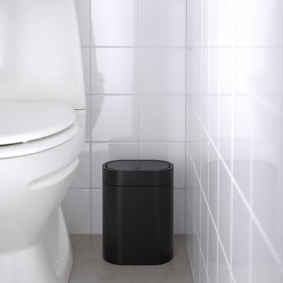 A black BROGRUND trash can with a sleek, slim design. It a press-open lid, wall-mount capability, and handles for easy bag attachment.
