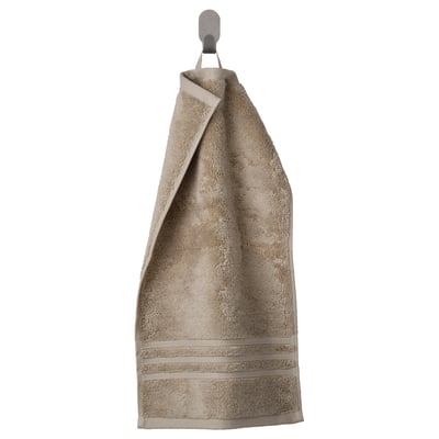 BROKGLIM gray towel with ribbed texture and striped border hangs neatly on a hook.