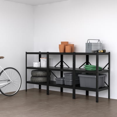 BROR black metal shelf stores tires, pots, tools in garage.