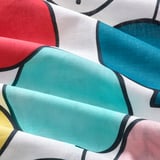 Vibrant abstract duvet cover with teal, red, and yellow shapes on white cotton. High-quality, sustainably sourced fabric, soft and durable.