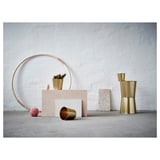 Minimalist home decor: gold pots, round rack, pastel plants. Unseen must feel texture and color contrast.