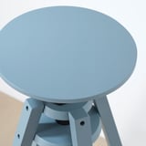 Light blue modern stool with round seat, sturdy metal legs, height adjustable. Quality design, smooth surfaces, robust construction.
