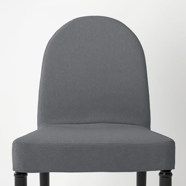 Chic gray dining chair with sleek black legs, offering comfort and style. Perfect for modern home decor.