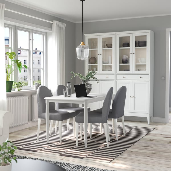 Modern dining room with white DANDERYD table, gray chairs, and large window.