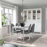 Modern dining room with white DANDERYD table, gray chairs, and large window.