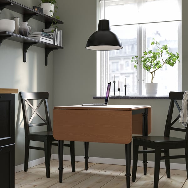 DANDERYD drop-leaf table with 2 chairs, extendable, near large window with lamp.