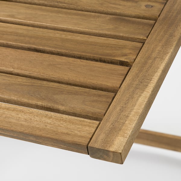 Close-up of a sturdy wooden table, showing detailed slatted design and natural finish.