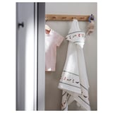 Wooden hanger with hooks, pink baby shirt, white hooded towel with colorful dog prints.