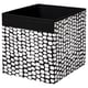 Black & white dot patterned square fabric storage box with handles.