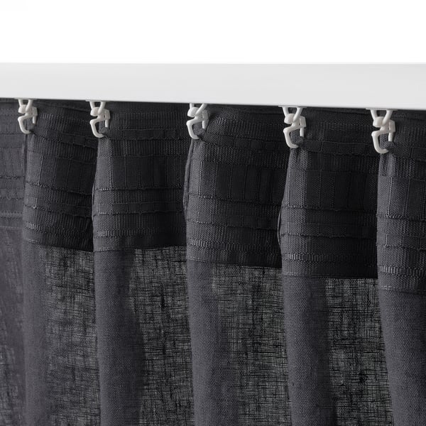 Linen curtains offer privacy, allowing light through while adding a casual vibe.