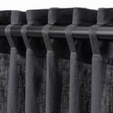 Black curtains with looped rod pockets, designed to hang and provide privacy while allowing light through.