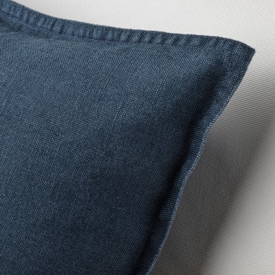 A blue square DYTÅG cushion cover made of linen with a zipper closure.