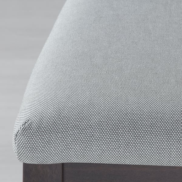 Close-up of neatly upholstered cushion, showcasing high-quality fabric texture.