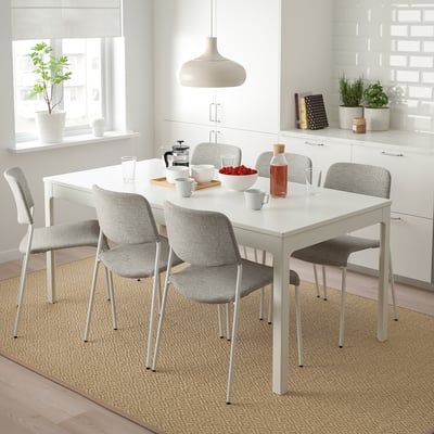 Modern white 6-seat dining set with extendable table and comfy, stackable chairs. Bright, clean design fits well in spacious kitchen or dining area.