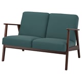 Vintage-style teal sofa with dark wood frame and angled back.