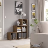 Modern living room with light furniture. Wooden EKET unit holds books, art, and a plant.