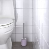 Purple toilet brush in holder, placed near white toilet, for easy cleaning.