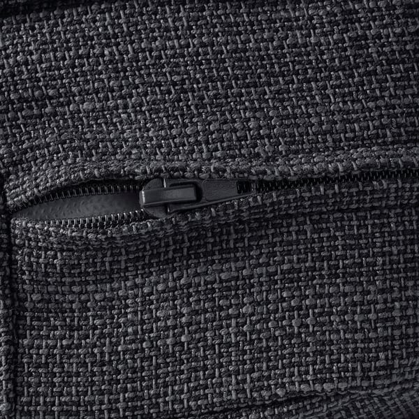 Close-up view of fine-textured, dark fabric with robust zipper detail. Highlights quality and durability.