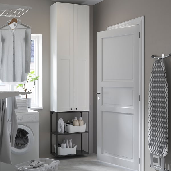 Modern laundry room with ENHET cabinets, washing machine, and garment rack.