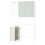 A white ENHET laundry storage unit with green doors, featuring open shelves and a hanging laundry bag.