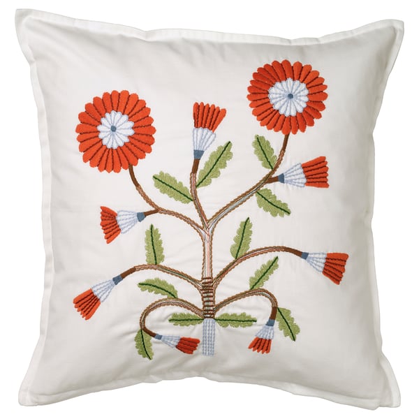 White square cushion with hand-embroidered orange and blue flowers, green leaves, on soft cotton.