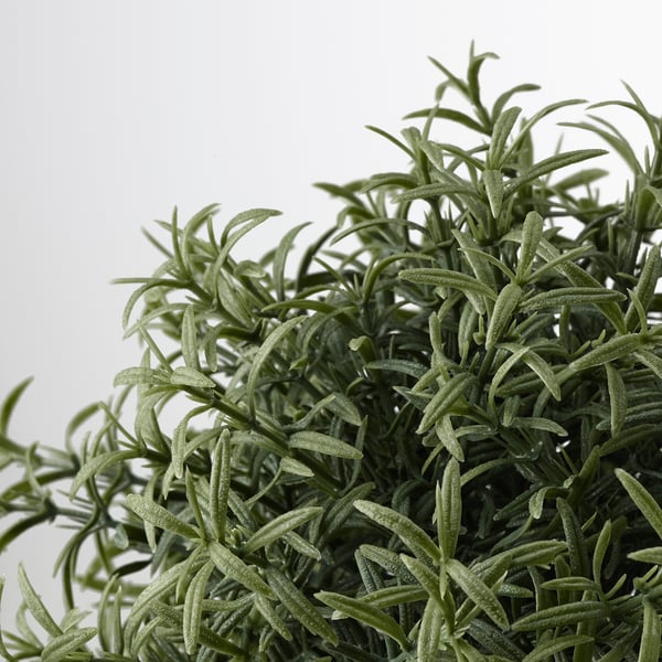 A lush, realistic artificial plant with vibrant green foliage, potted and ready for display.