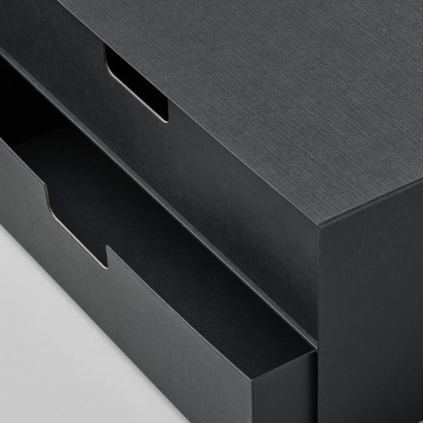 Black cardboard storage box with three drawers, showing sleek design and sturdy construction, ideal for organizing small items.