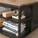 Black metal and wood storage table with open shelves, displaying books and game set.