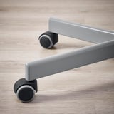 Close-up of grey ergonomic office chairs castor on light wooden floor. Shows smooth, durable design.